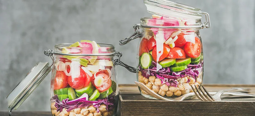 Vegetable and chickpea salads in glass jars